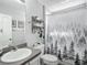 Clean bathroom featuring a vanity, toilet, and shower with nature-themed curtain at 7474 Se 172Nd Fieldcrest St, The Villages, FL 32162