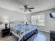 Bedroom with wood floors, ceiling fan, and window providing natural light at 7474 Se 172Nd Fieldcrest St, The Villages, FL 32162