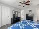This is a bedroom featuring wood-look floors, neutral paint, and a modern ceiling fan at 7474 Se 172Nd Fieldcrest St, The Villages, FL 32162