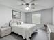 Comfortable bedroom with ceiling fan, dresser, and window at 7474 Se 172Nd Fieldcrest St, The Villages, FL 32162