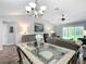 Dining room with glass table and views into the living area at 7474 Se 172Nd Fieldcrest St, The Villages, FL 32162