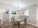 Vaulted dining room with laminate floors, neutral walls and pass-through to kitchen at 7474 Se 172Nd Fieldcrest St, The Villages, FL 32162