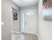 Welcoming entryway with neutral walls, wood-look flooring, and a stylish front door at 7474 Se 172Nd Fieldcrest St, The Villages, FL 32162
