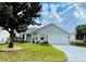 Charming single-story home with a well-manicured lawn and an attached two-car garage at 7474 Se 172Nd Fieldcrest St, The Villages, FL 32162