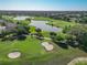 Scenic aerial shot of a golf course featuring lush greenery, sand traps, and a tranquil lake at 7474 Se 172Nd Fieldcrest St, The Villages, FL 32162