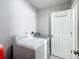 Bright laundry room with modern washer and dryer appliances, and convenient access to storage at 7474 Se 172Nd Fieldcrest St, The Villages, FL 32162