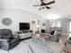 Inviting living room with ceiling fan, wood floors, and modern furnishings at 7474 Se 172Nd Fieldcrest St, The Villages, FL 32162