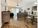 Open floorplan shows spacious living room and dining room with wood floors at 7474 Se 172Nd Fieldcrest St, The Villages, FL 32162