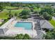 Aerial view of a community pool with a white pergola and ample seating area at 7474 Se 172Nd Fieldcrest St, The Villages, FL 32162