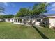 Expansive backyard featuring a well-maintained lawn, a sunroom, and a cozy patio area perfect for outdoor enjoyment at 9069 Sw 96Th Ln # B, Ocala, FL 34481