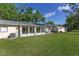 Green backyard with a sunroom, and a patio, perfect for outdoor entertaining and relaxation at 9069 Sw 96Th Ln # B, Ocala, FL 34481