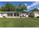 Lush backyard with a sunroom addition and a patio, ideal for entertaining and enjoying outdoor living at 9069 Sw 96Th Ln # B, Ocala, FL 34481
