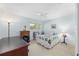Cozy bedroom features a ceiling fan, large window and neutral carpeting at 9069 Sw 96Th Ln # B, Ocala, FL 34481