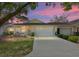 Charming single-story home features a well-manicured lawn and attached two-car garage beneath a colorful sunset sky at 9069 Sw 96Th Ln # B, Ocala, FL 34481