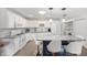 Bright kitchen features white cabinetry, stainless appliances, granite countertops and island with bar seating at 9069 Sw 96Th Ln # B, Ocala, FL 34481