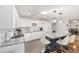 Bright kitchen featuring white cabinets, a gray island, and stainless steel appliances at 9069 Sw 96Th Ln # B, Ocala, FL 34481