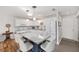 Bright kitchen boasts white cabinetry, stainless appliances, granite countertops and island with bar seating at 9069 Sw 96Th Ln # B, Ocala, FL 34481