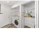 Convenient laundry room features a washer, dryer, storage shelves and additional access door at 9069 Sw 96Th Ln # B, Ocala, FL 34481