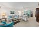 Bright living room with comfortable seating, neutral decor, ceiling fan, and a view into the dining area at 9069 Sw 96Th Ln # B, Ocala, FL 34481