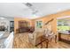 Bright living room with laminate floors, furniture, and a sliding glass door to patio at 9069 Sw 96Th Ln # B, Ocala, FL 34481