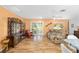 Open living room with laminate floors, a tan sofa, and direct access to an outdoor patio at 9069 Sw 96Th Ln # B, Ocala, FL 34481