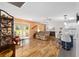 Open-concept living space with wood floors, leading to kitchen and outdoor patio at 9069 Sw 96Th Ln # B, Ocala, FL 34481