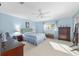 Main bedroom with ceiling fan and lots of windows and furniture at 9069 Sw 96Th Ln # B, Ocala, FL 34481