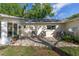 Paver patio with outdoor seating, adjacent to the home's sunroom and backyard at 9069 Sw 96Th Ln # B, Ocala, FL 34481