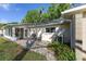Charming patio area with stone pavers, seating, and access to a sunroom, creating a relaxing outdoor space at 9069 Sw 96Th Ln # B, Ocala, FL 34481