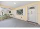 Inviting front porch with white railings, a gray mat, and direct access to the home's main entrance at 9069 Sw 96Th Ln # B, Ocala, FL 34481