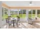 Bright sunroom with lots of windows, tile floors, and a ceiling fan at 9069 Sw 96Th Ln # B, Ocala, FL 34481