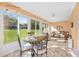 Bright and spacious sunroom with lots of windows, tile floors, and comfortable seating at 9069 Sw 96Th Ln # B, Ocala, FL 34481