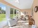 Relaxing sunroom with lots of windows, tile floors, and comfortable furniture at 9069 Sw 96Th Ln # B, Ocala, FL 34481