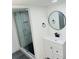 Modern bathroom with glass shower, vanity, contemporary mirror, and stylish fixtures at 9247 Se 142Nd Pl, Summerfield, FL 34491