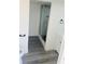 Bathroom showcasing marble shower, black hexagon floors, white vanity and modern lighting at 9247 Se 142Nd Pl, Summerfield, FL 34491
