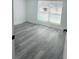 Cozy bedroom with wood floors, bright light, and white walls at 9247 Se 142Nd Pl, Summerfield, FL 34491