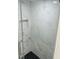 Modern tiled shower with marble tile, glass door, black hexagonal floor and built-in niche at 9247 Se 142Nd Pl, Summerfield, FL 34491