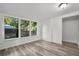 This bedroom features three windows and wood-look flooring at 935 Ne Sanchez Ave, Ocala, FL 34470
