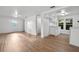 Bright, freshly painted interior with modern flooring, complemented by a kitchen and ample natural light at 935 Ne Sanchez Ave, Ocala, FL 34470