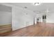 Inviting living space featuring laminate flooring, fresh white walls, and access to other rooms at 935 Ne Sanchez Ave, Ocala, FL 34470
