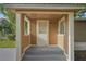 Welcoming covered porch with freshly painted steps and pillars, leading to the home's entrance at 935 Ne Sanchez Ave, Ocala, FL 34470