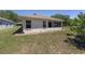 Home exterior showing rear windows and a view of the screened patio at 9541 Sw 93Rd Loop, Ocala, FL 34481