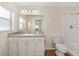 Bathroom features a shower-tub combo and vanity with granite countertop at 9541 Sw 93Rd Loop, Ocala, FL 34481
