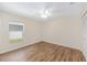 Bedroom features wood-look floors and closet, plus a ceiling fan at 9541 Sw 93Rd Loop, Ocala, FL 34481