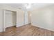 Bright bedroom features wood floors, closet, ceiling fan, and access to another room at 9541 Sw 93Rd Loop, Ocala, FL 34481