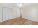 Bedroom with wood-look floors, closet and a ceiling fan at 9541 Sw 93Rd Loop, Ocala, FL 34481