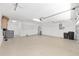 Spacious garage with painted floor, water heater, washer, and plenty of storage space at 9541 Sw 93Rd Loop, Ocala, FL 34481