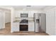 Bright kitchen features stainless steel appliances, granite countertops and white cabinetry at 9541 Sw 93Rd Loop, Ocala, FL 34481