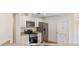 Updated kitchen featuring stainless steel appliances, granite counters, and white cabinets at 9541 Sw 93Rd Loop, Ocala, FL 34481