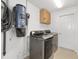 Laundry room with a newer washer and dryer, built in central vacuum system, and storage at 9541 Sw 93Rd Loop, Ocala, FL 34481